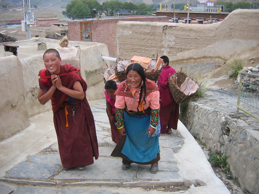 40-Female monks carrying bricks for the monastry.jpg - Female monks carrying bricks for the monastry